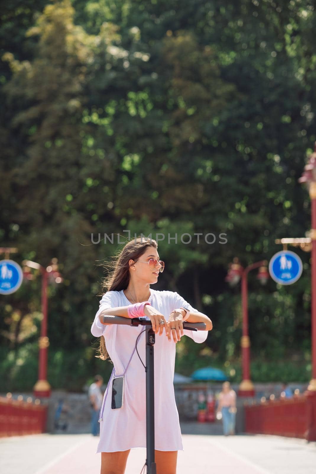 Young beautiful woman and an electric scooter, modern girl, new generation, electric transport, ecological transport