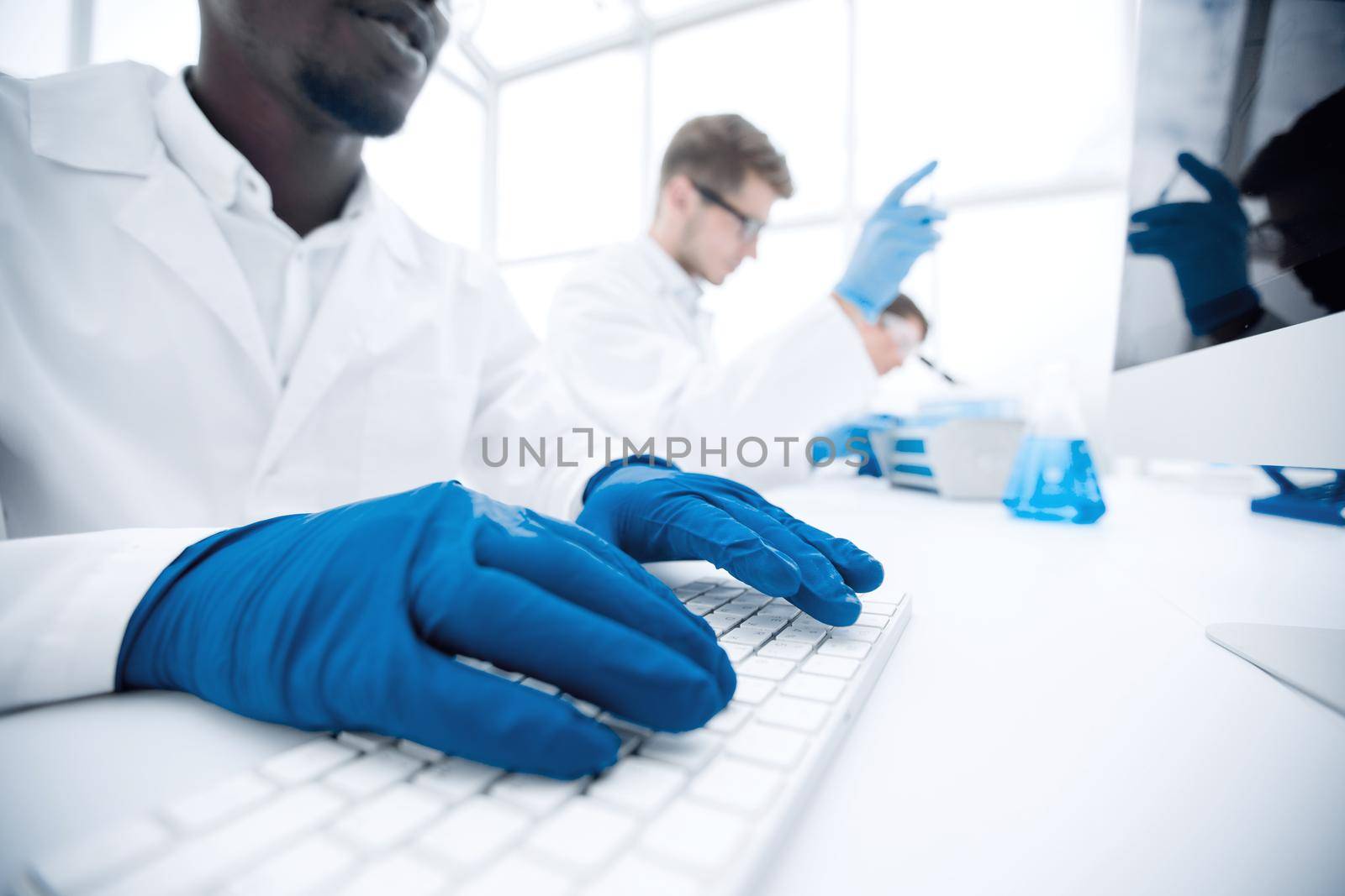 close up.scientist typing on computer keyboard.science and technology