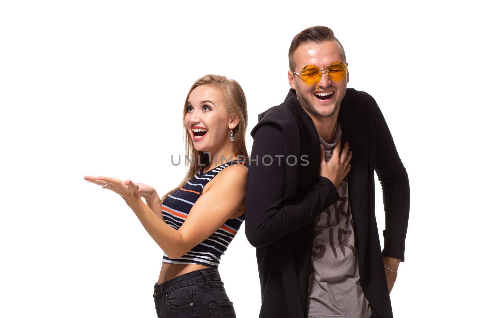 Couple watching look at something and have different emotions concept. Studio shot on white background. Copy space