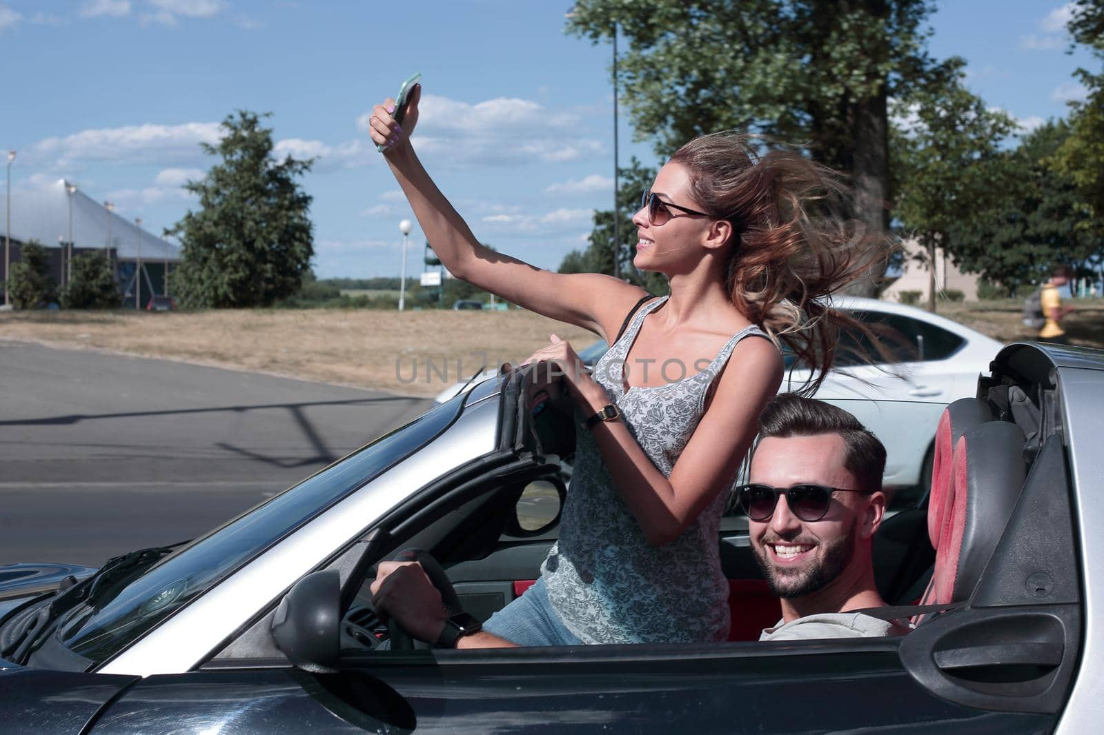 young woman taking a selfie in the car.travel together