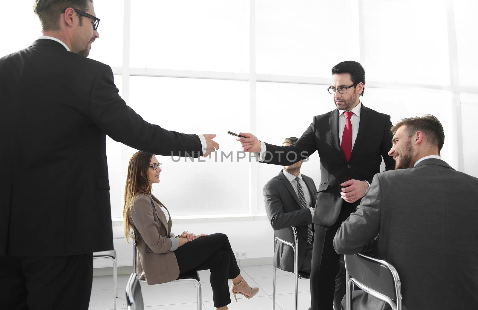 Business man giving a pen to a businessman for signing a contract