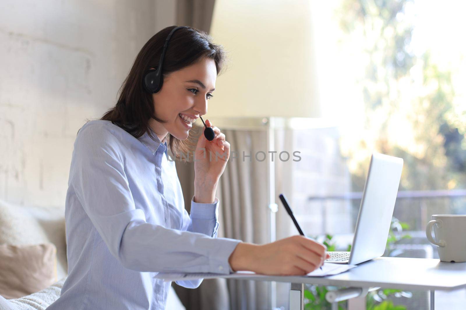 Freelance operator talking with headsets and consulting clients from home office