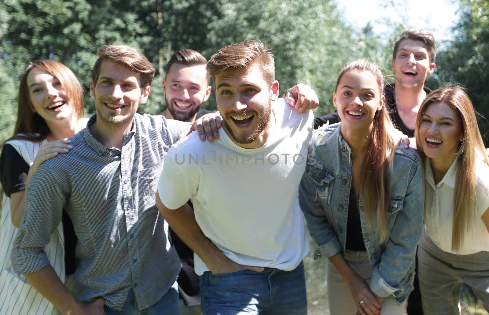 portrait of a group of friends on the background of the Park by asdf