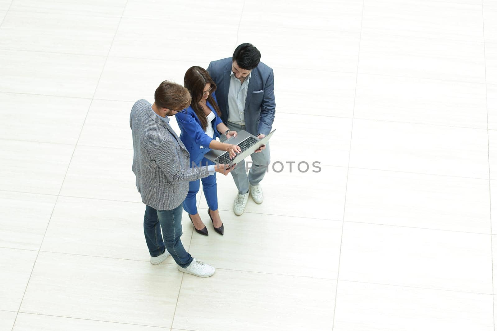 top view.the business team looks at the laptop screen by asdf