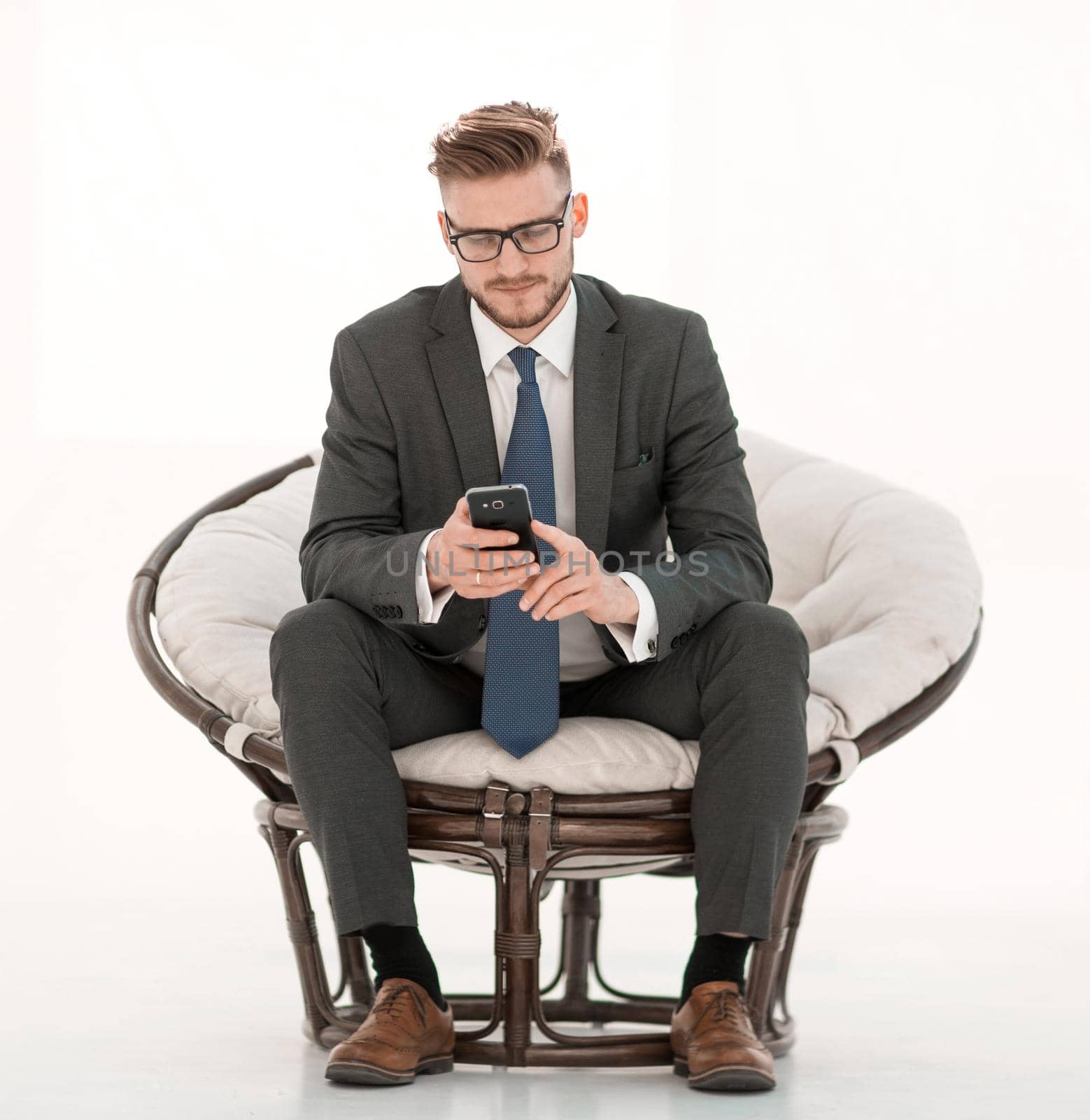 close up.successful businessman reading SMS on his smartphone.isolated on white