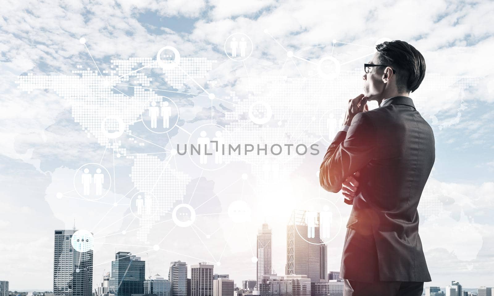 Young elegant businessman with hand on chin looking away