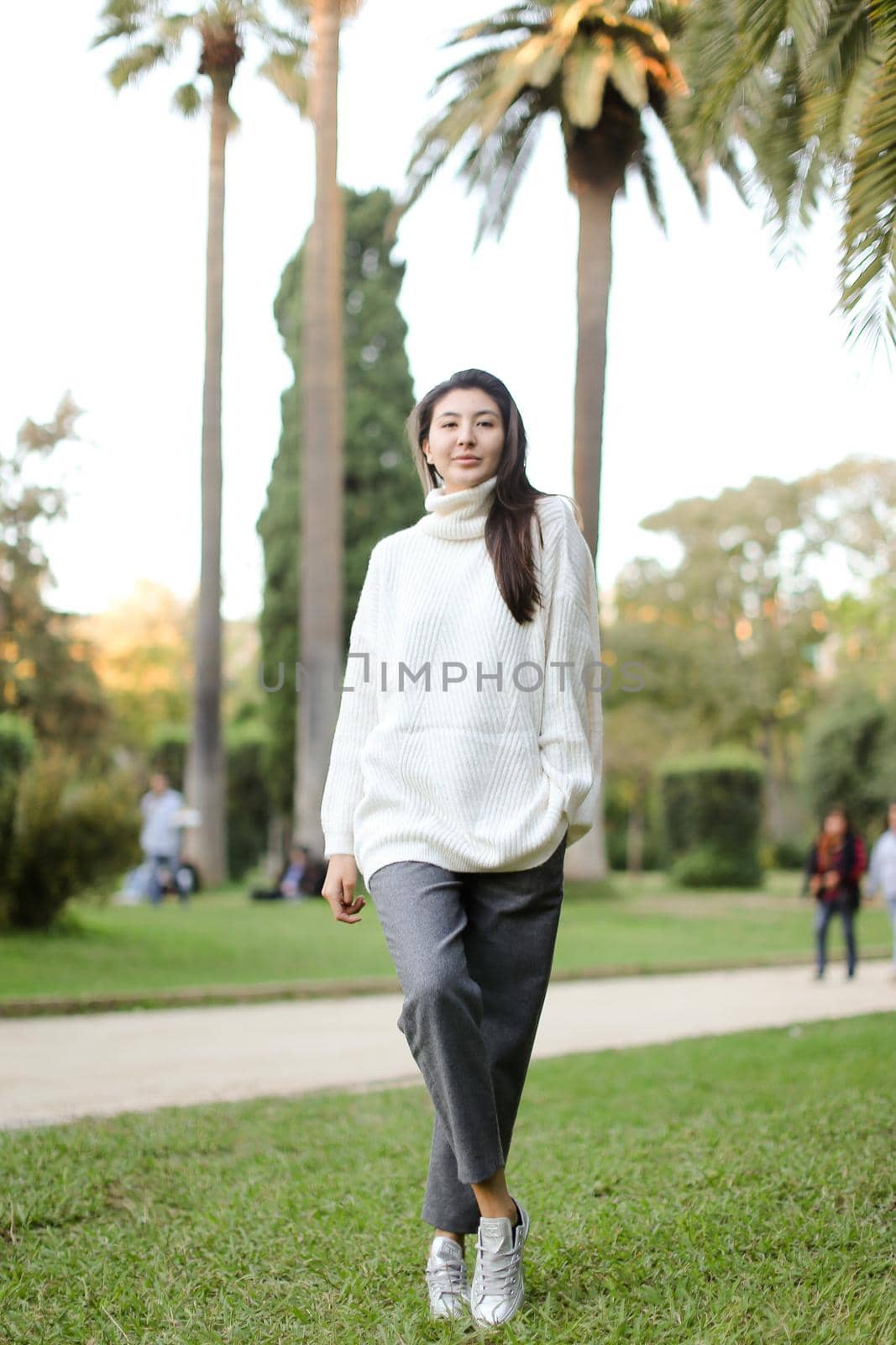 Asian stylish girl walking in tropical park. by sisterspro