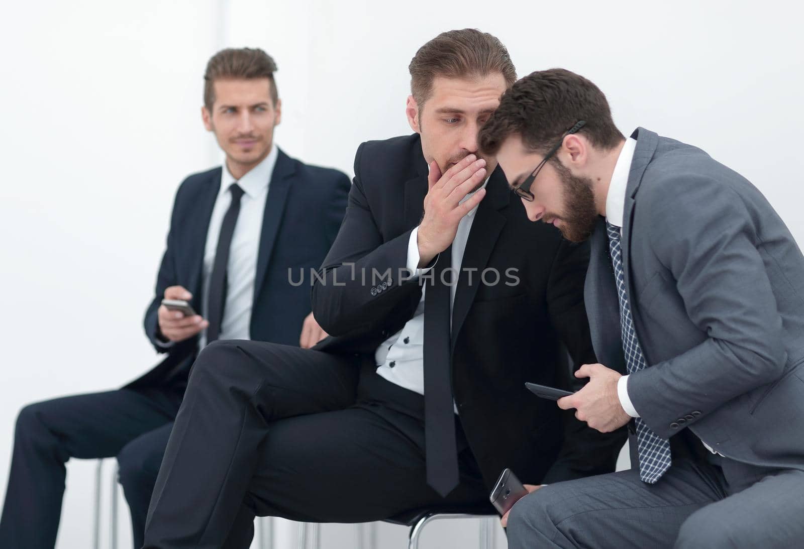 employees discuss the news, sitting in the office hallway by asdf