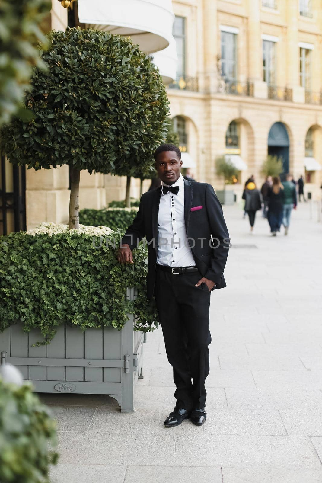 Afro american happy good looking man wearing suit and smiling outdoors. Concept of black businessman.