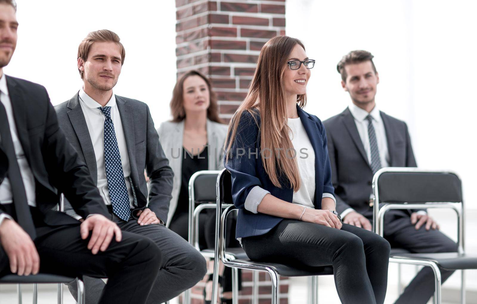 Businesswoman asking questions during seminar
