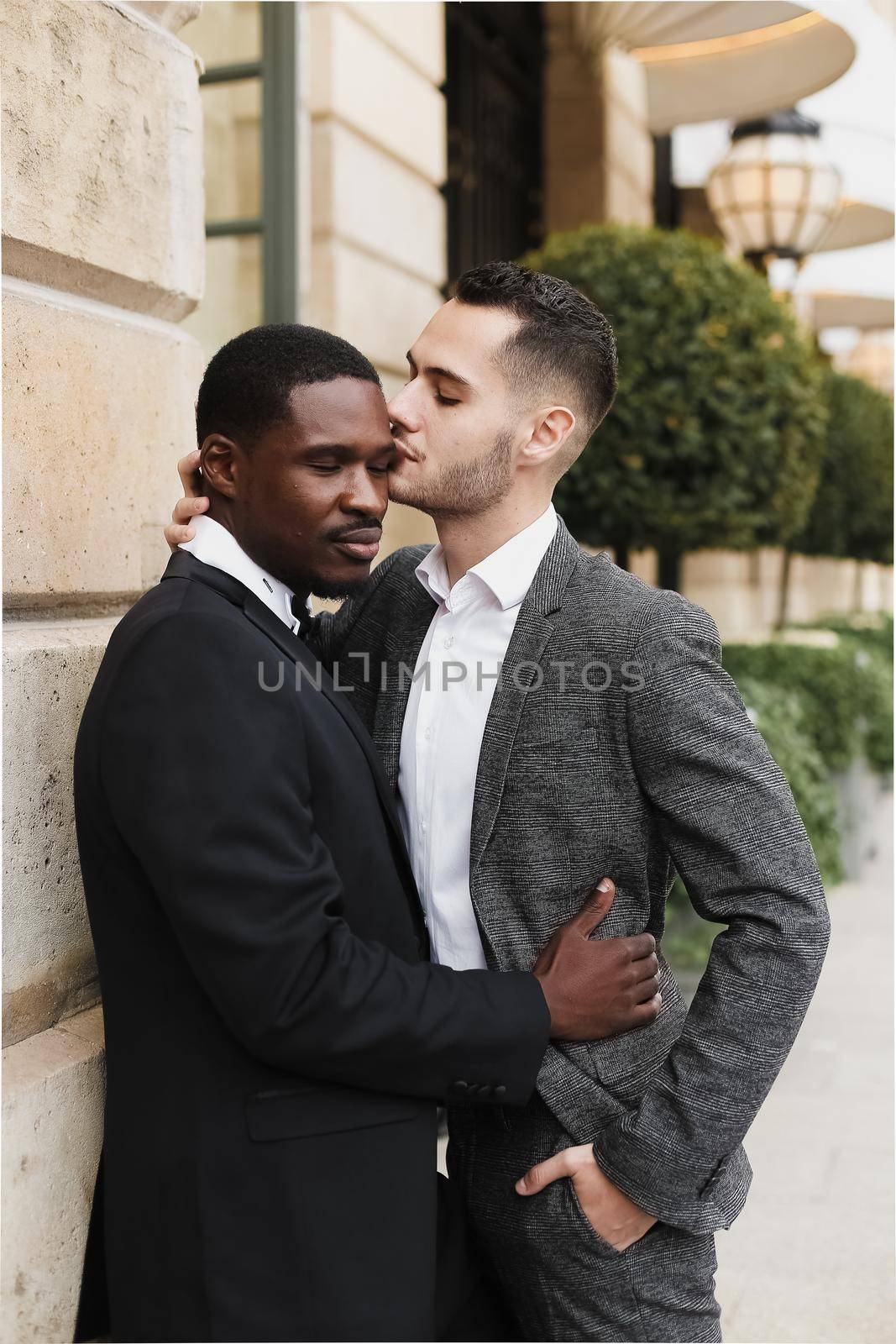 Afro american gay hugging european man outdoors. Concept of lgbt and same sex couple.