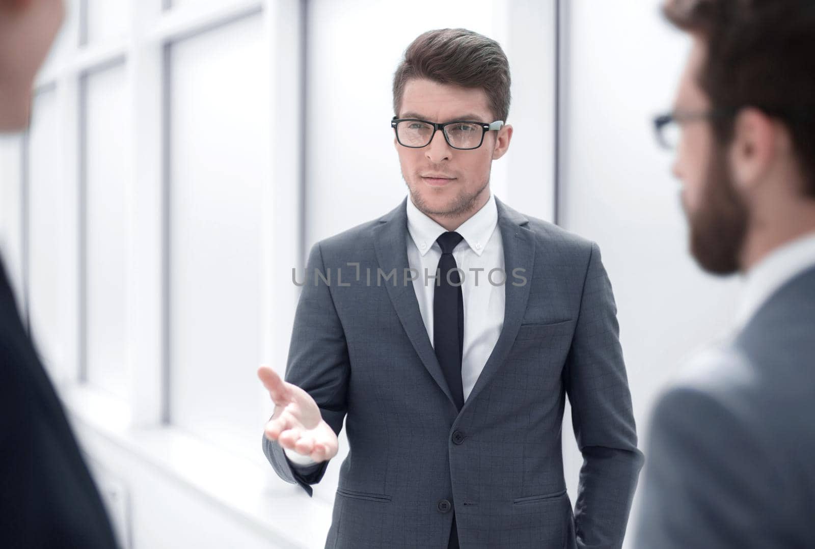 boss talking to employees standing in the office.business concept