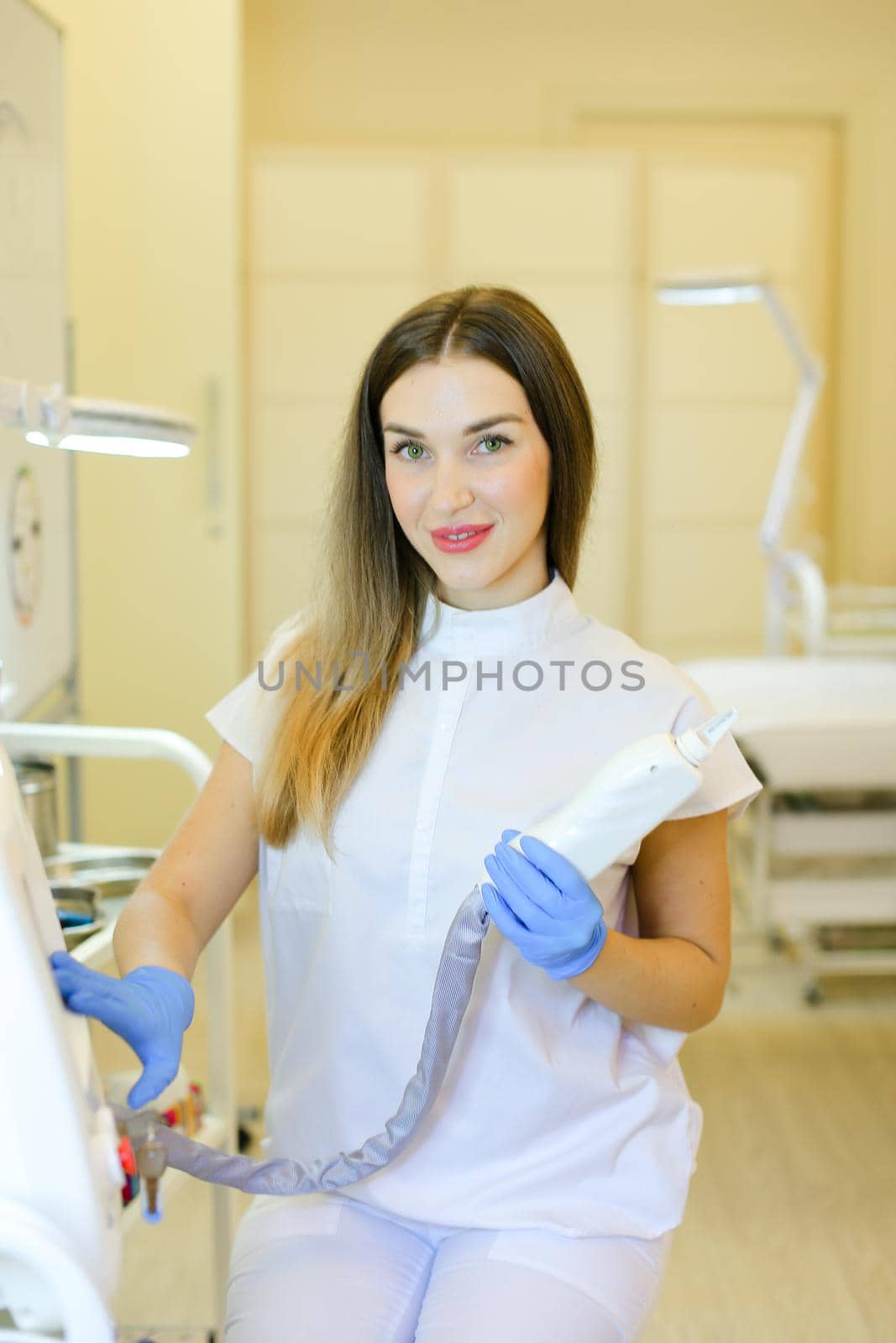 Skilled permanent makeup artist sitting with laser removal of tatoos device at beauty salon. Concept of cosmetology equipment and cosmetologist.