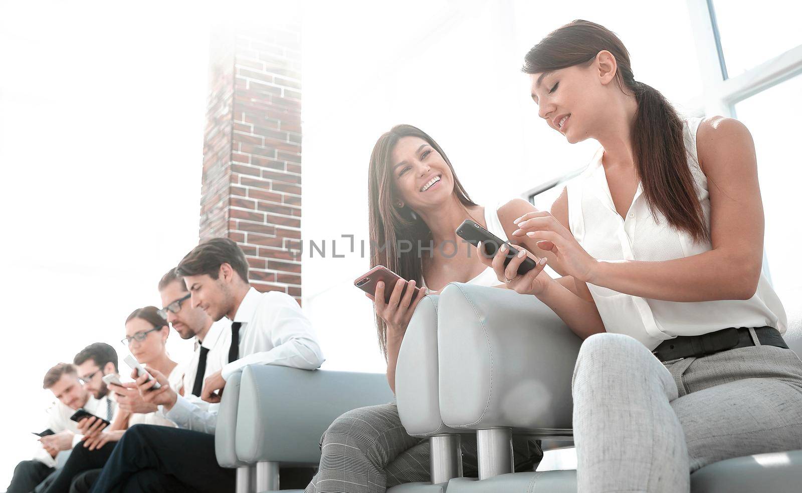 group of employees sitting in the office hallway by asdf