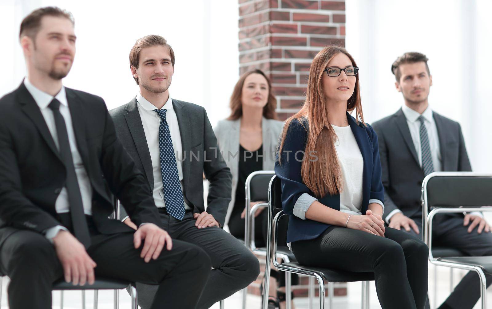 Businesswoman asking questions during seminar
