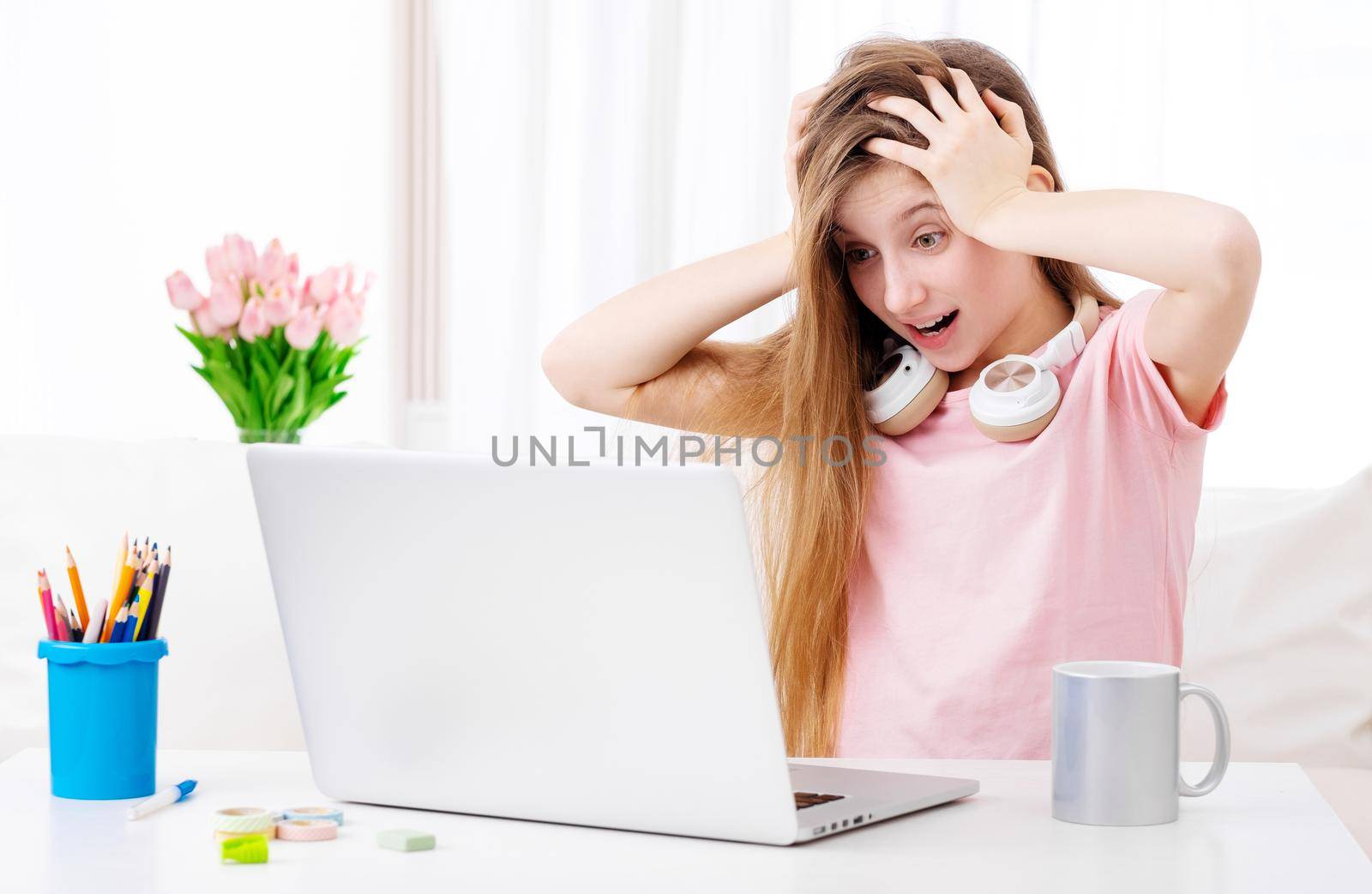 Beatiful girl is amazed about pictures on her personal laptop