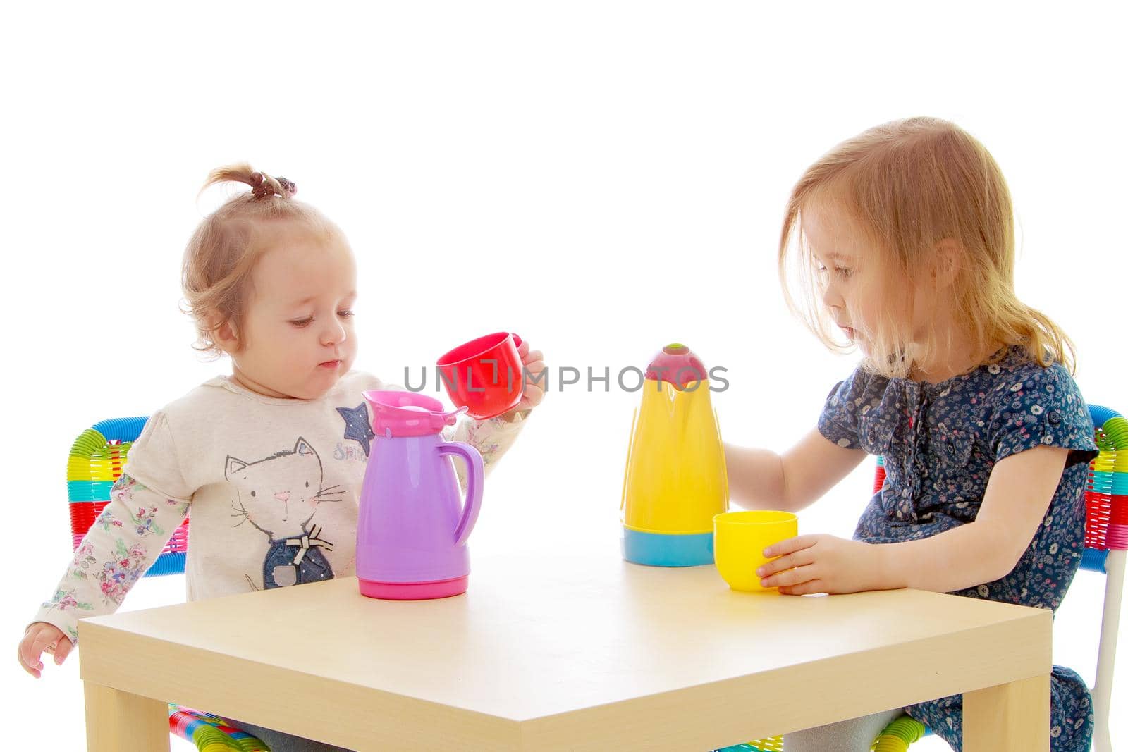 two sisters play fun playing. The concept of family happiness and development of children. Isolated over white background