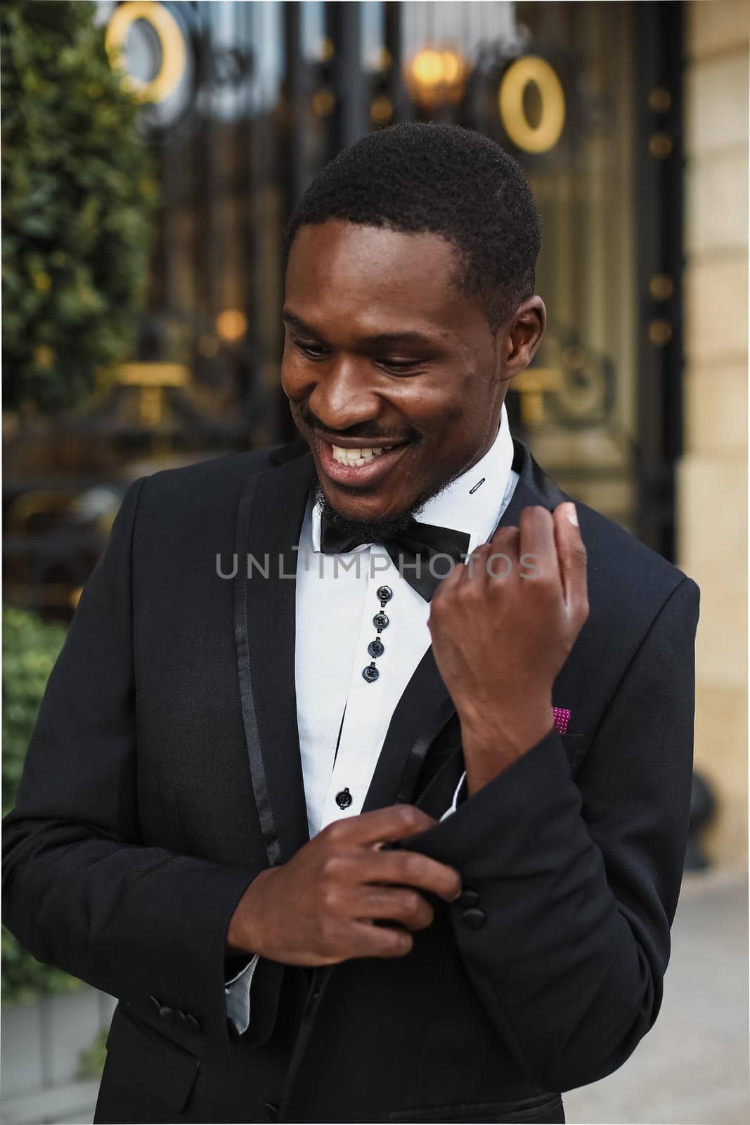 Afro american happy good looking man wearing suit and smiling outdoors. by sisterspro