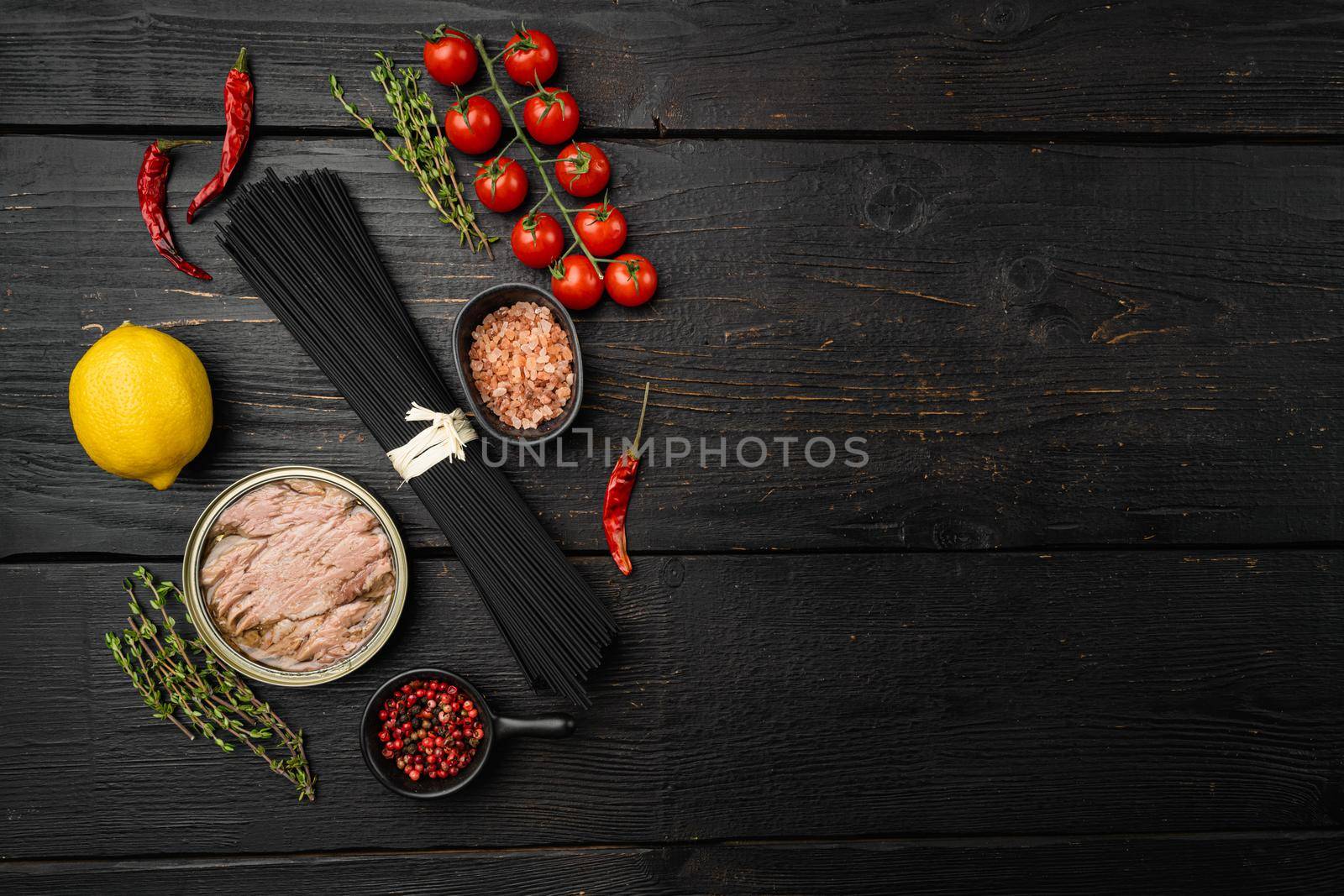 Raw and organic ingredients for healthy cooking set, on black wooden table background, top view flat lay, with copy space for text