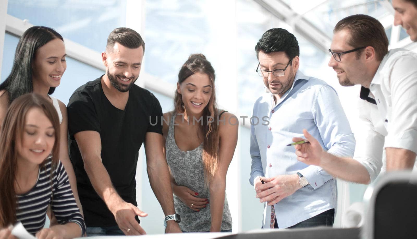 smiling team is working together on an architectural project. the concept of teamwork