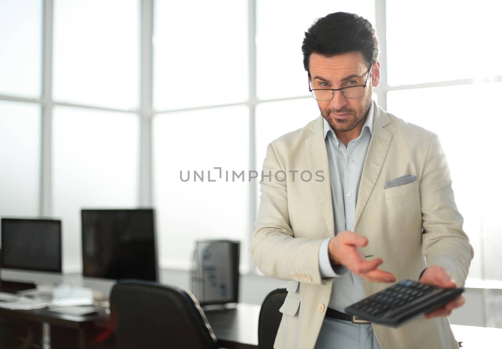 serious businessman using calculator.photo with copy space