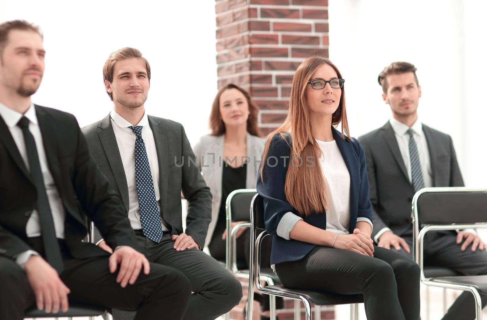 Businesswoman asking questions during seminar