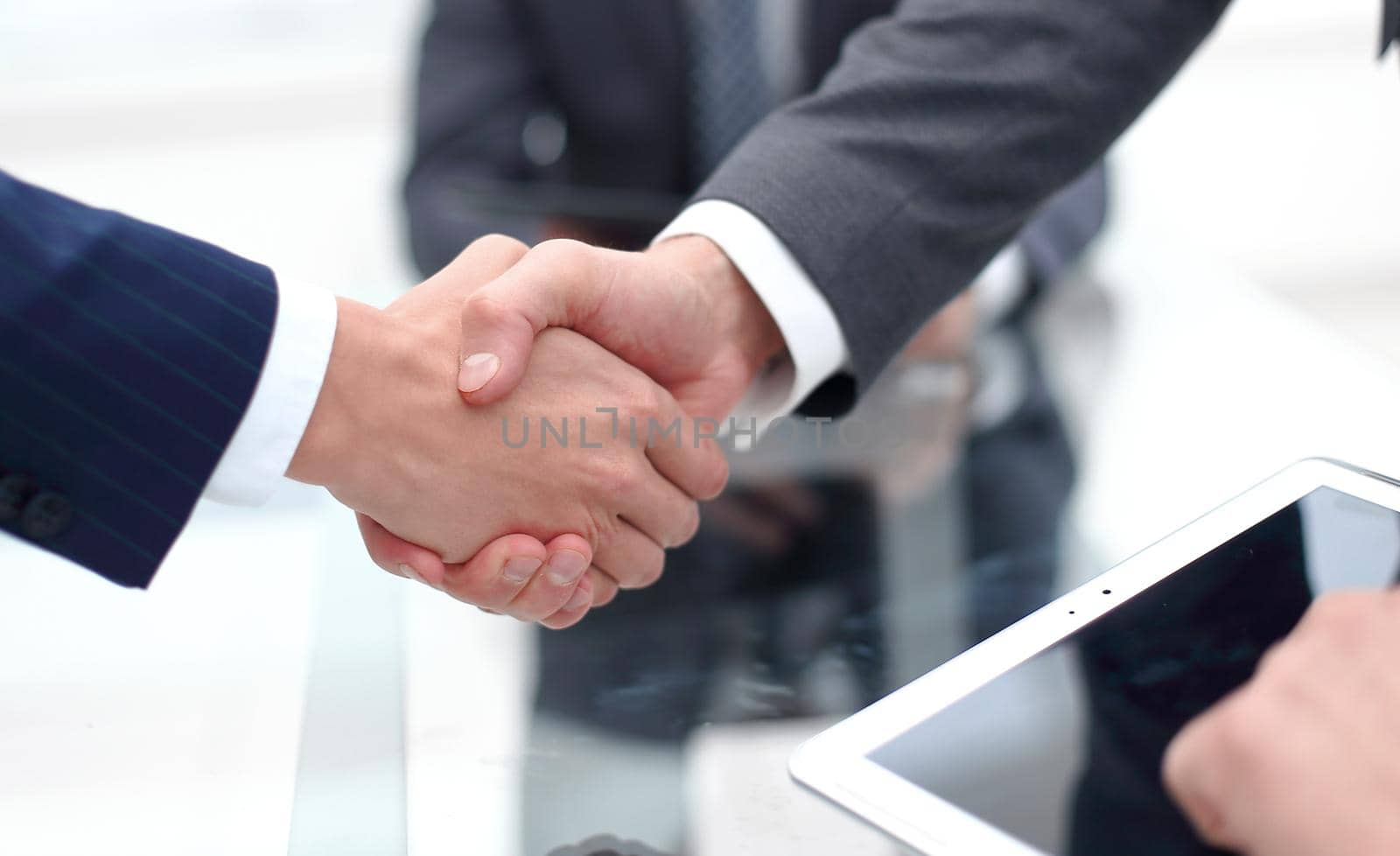 handshake business colleagues in office