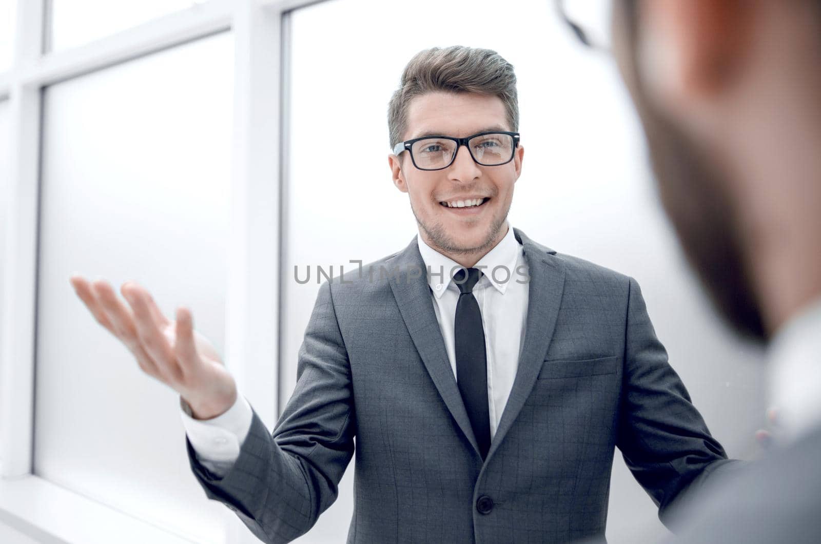 young businessman talking standing in the office.business concept