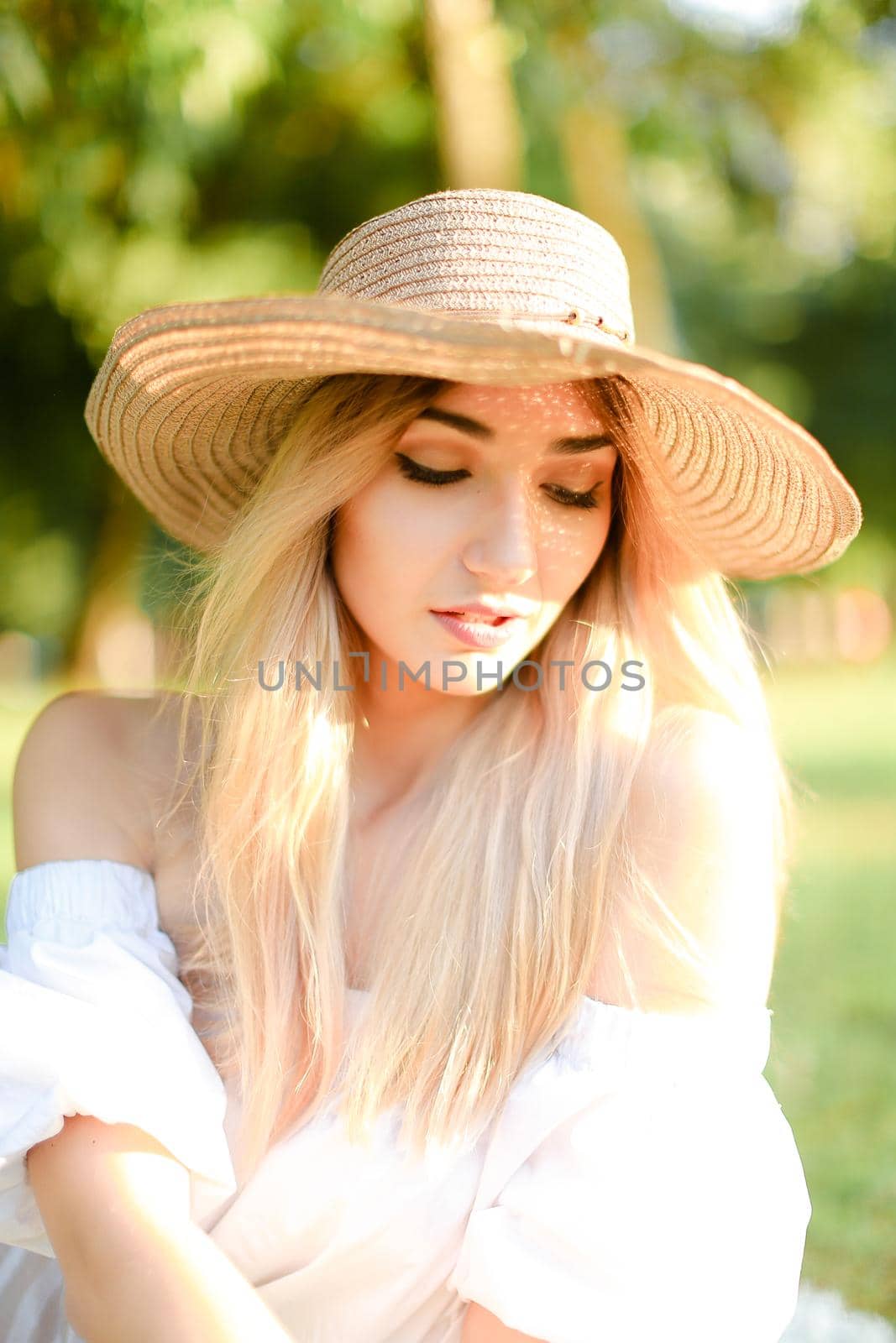 Portrait of young blonde caucasian girl in hat. Concept of beauty, female person and summer fashion.