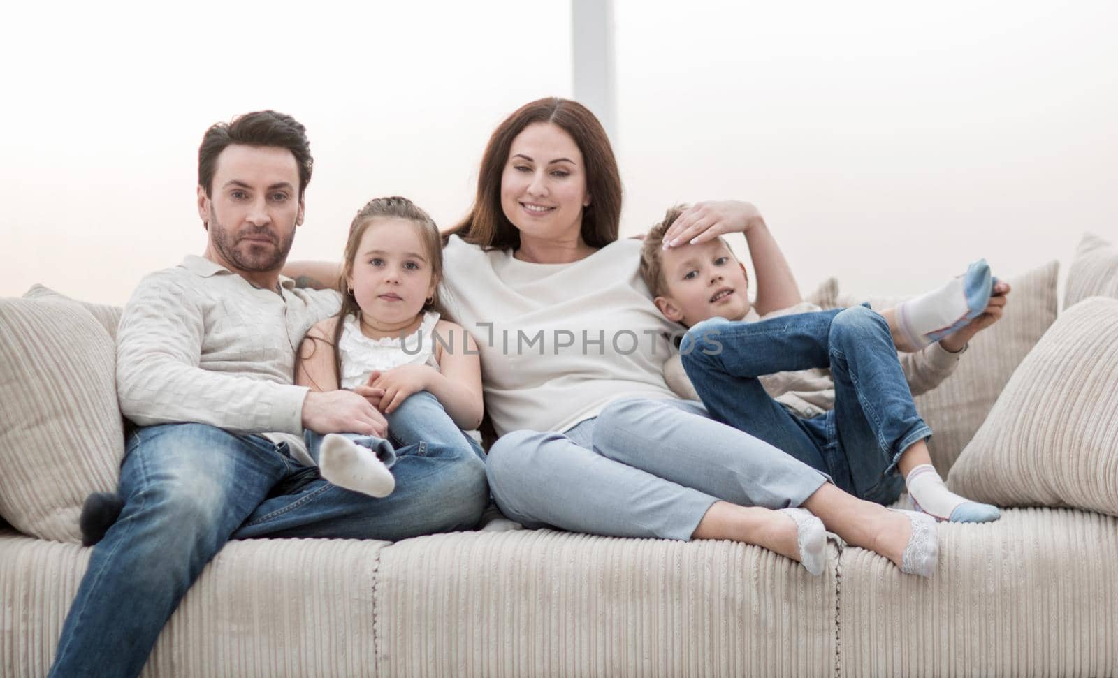 family sitting on the couch in the free evening.photo with copy space