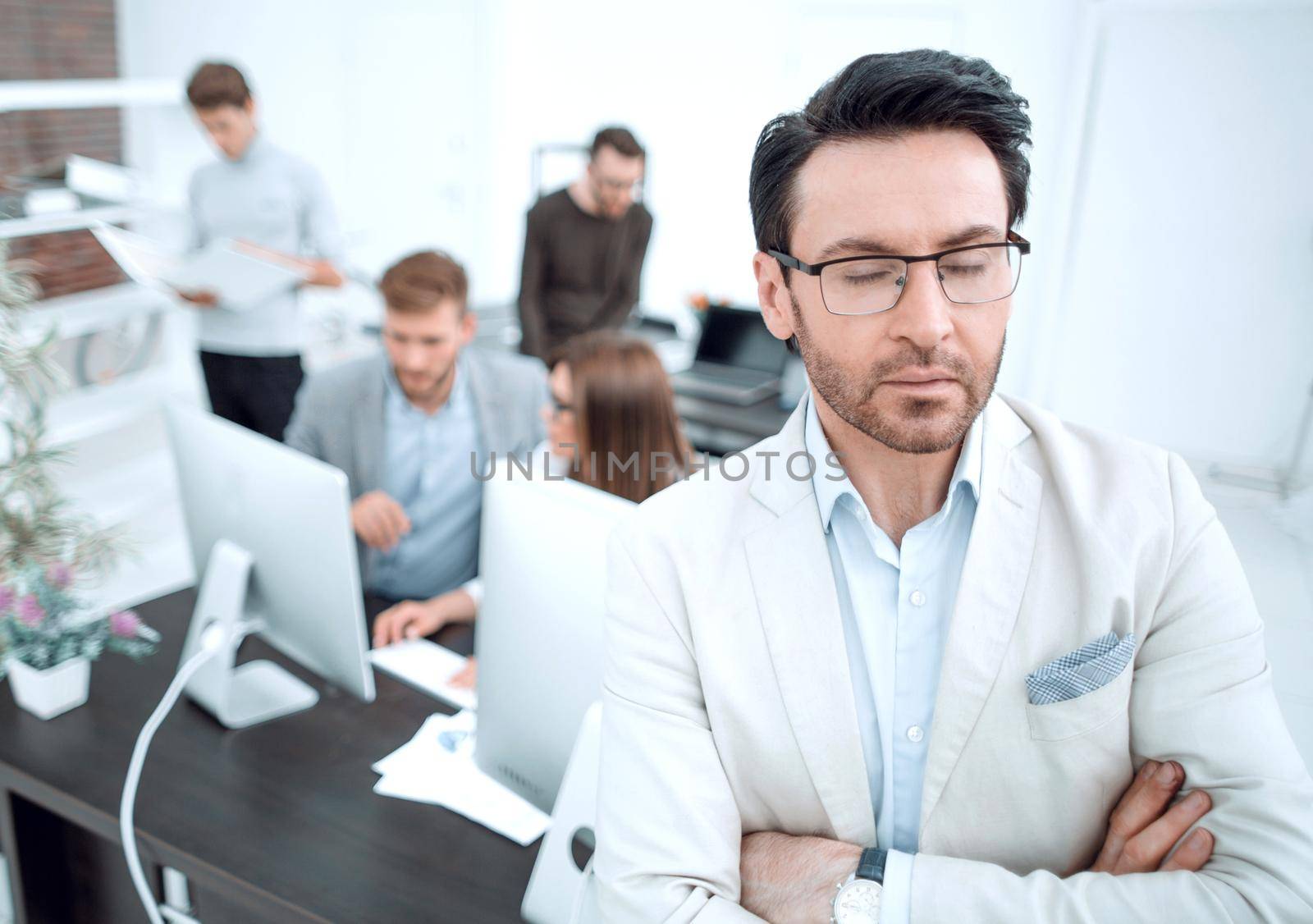 pensive businessman standing in his office.business people