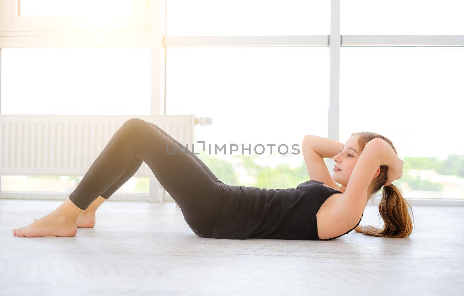 Pretty young girl doing abs exercises by GekaSkr
