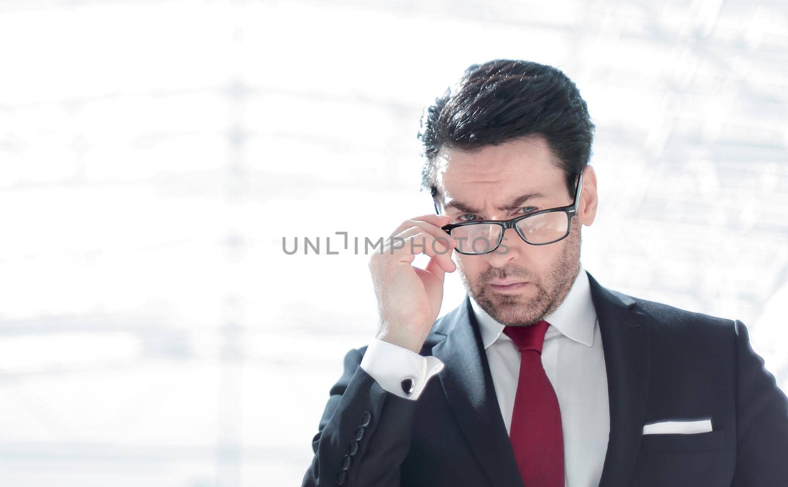 serious businessman looks over his glasses .photo with copy space