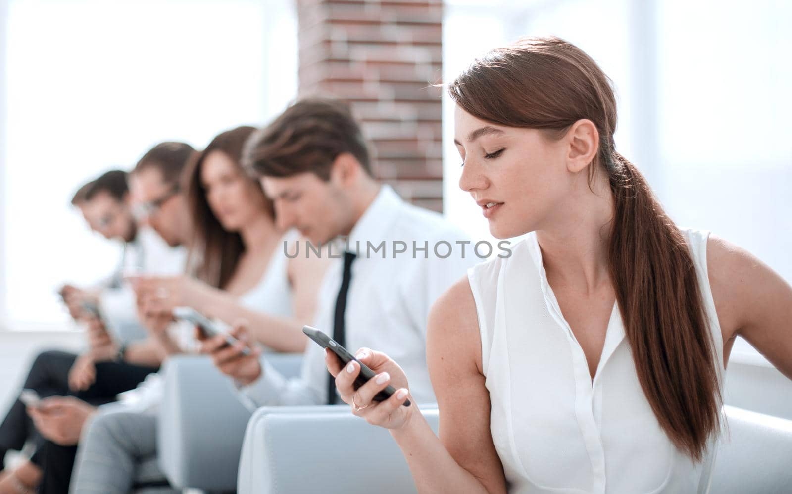 young employee looking at text message on smartphone.photo with copy space