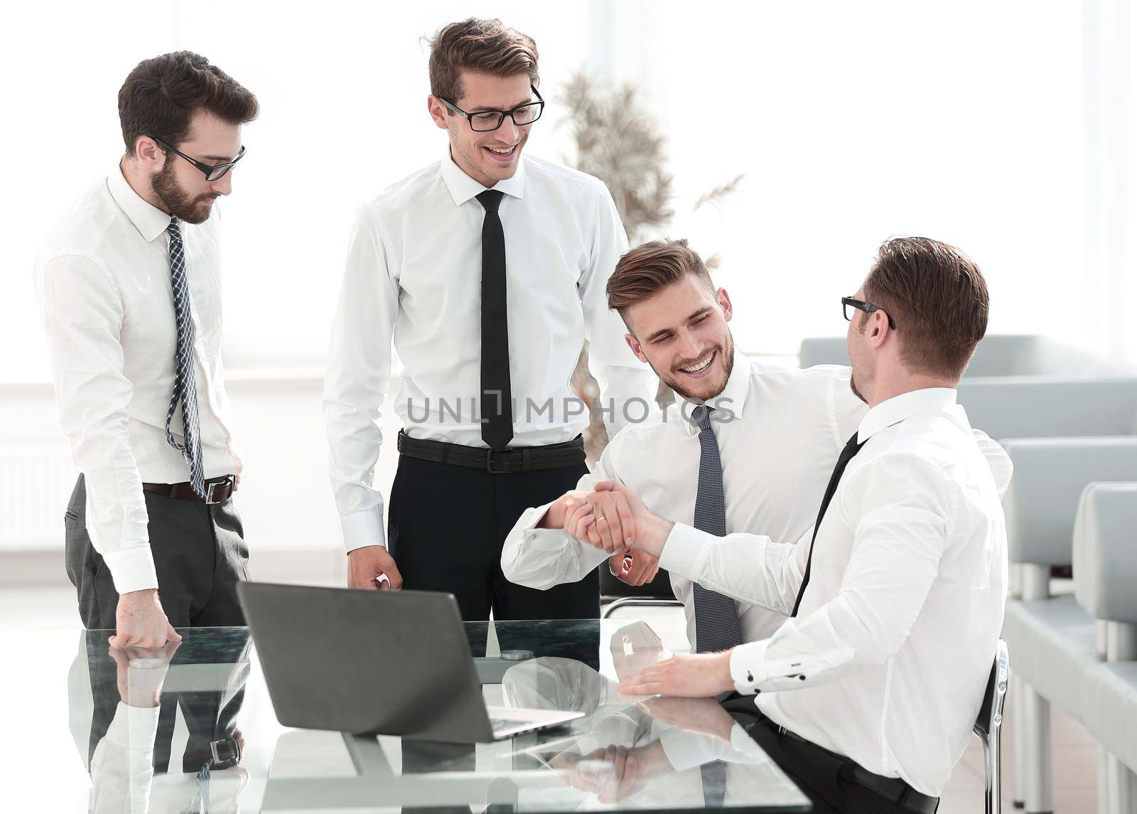 happy employees shaking hands .success concept