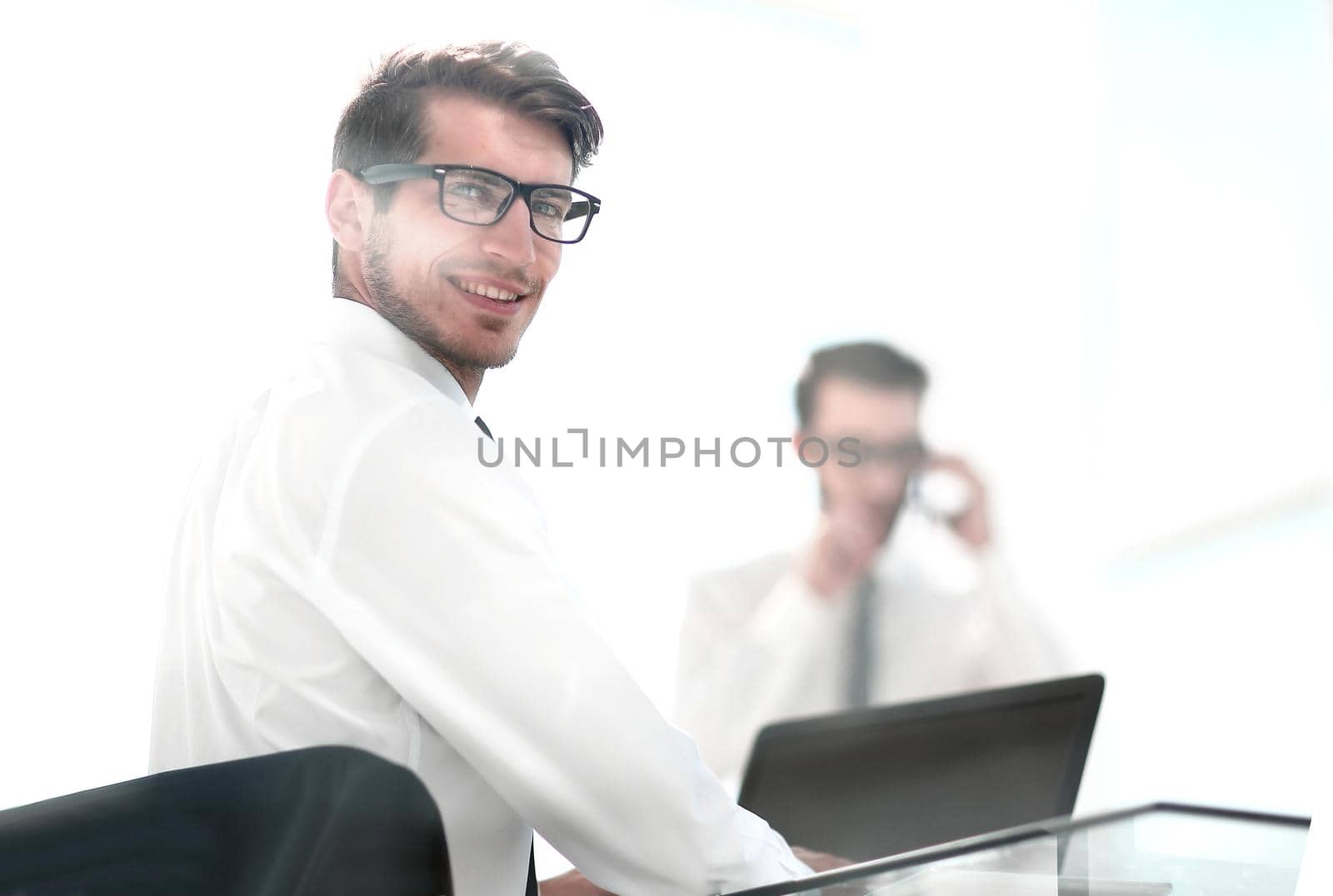 rear view.employees sitting at the office Desk.business background.