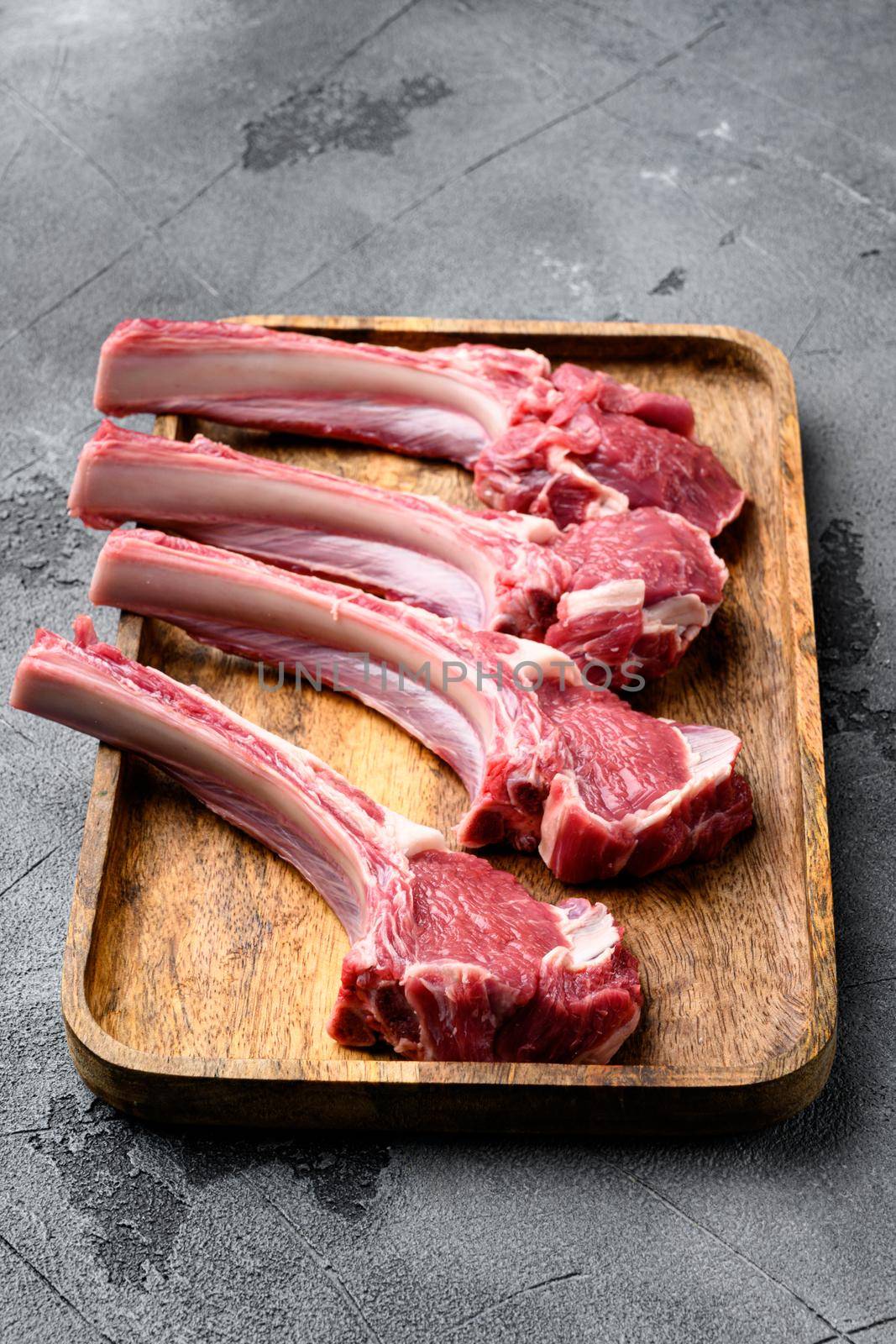 Raw lamb chops or mutton cuts set, on gray stone table background