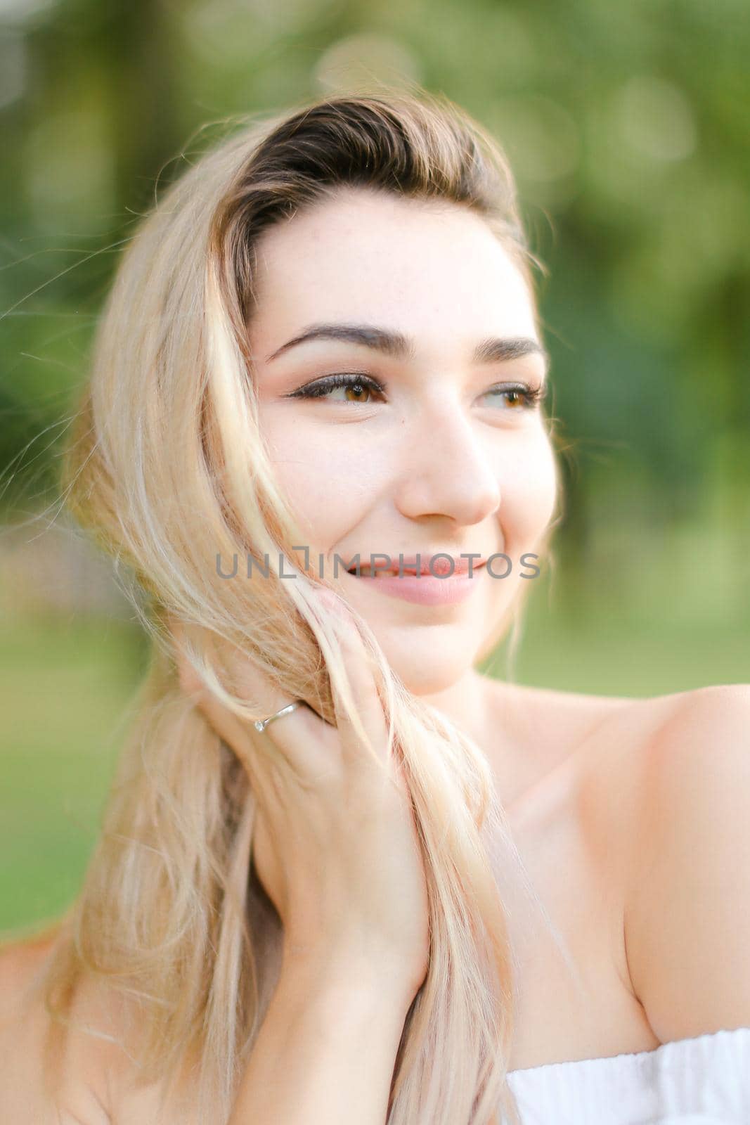 Portrait of young pretty girl, green background. Concept of beauty and everyday makeup.