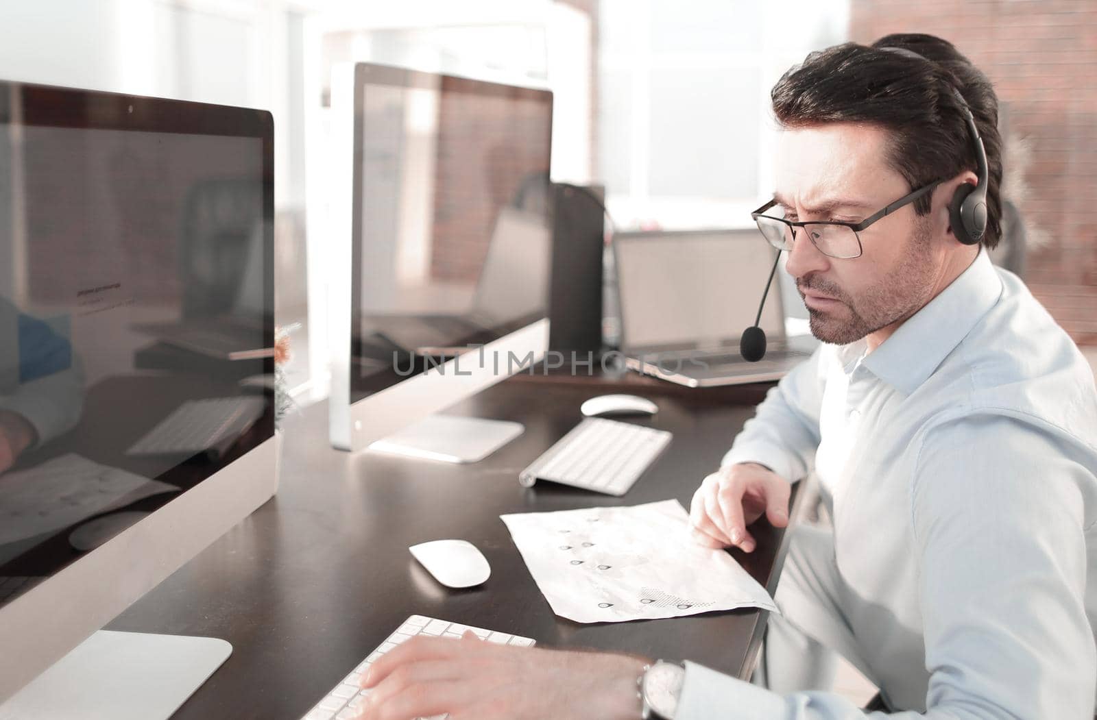 businessman analyzes the data sitting in the office.people and technology