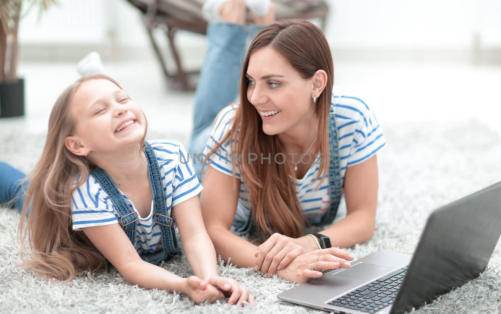 close up.mom and her little daughter playing on the laptop.people and technology