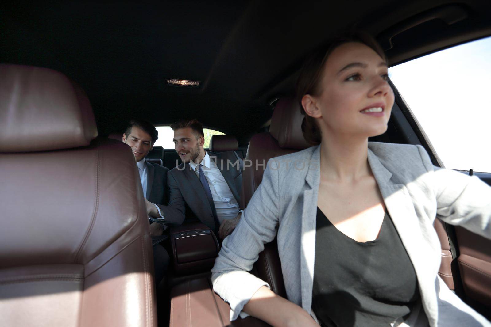 business team sitting in a modern car. business-trip