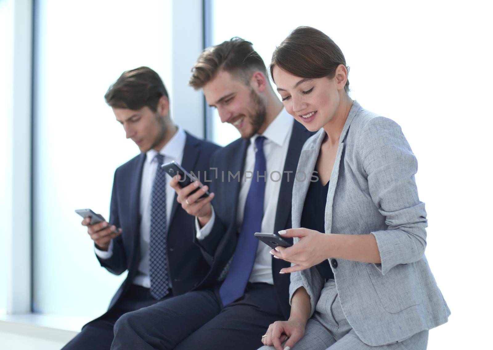 group of young people with gadgets sitting in a row.photo with copy space