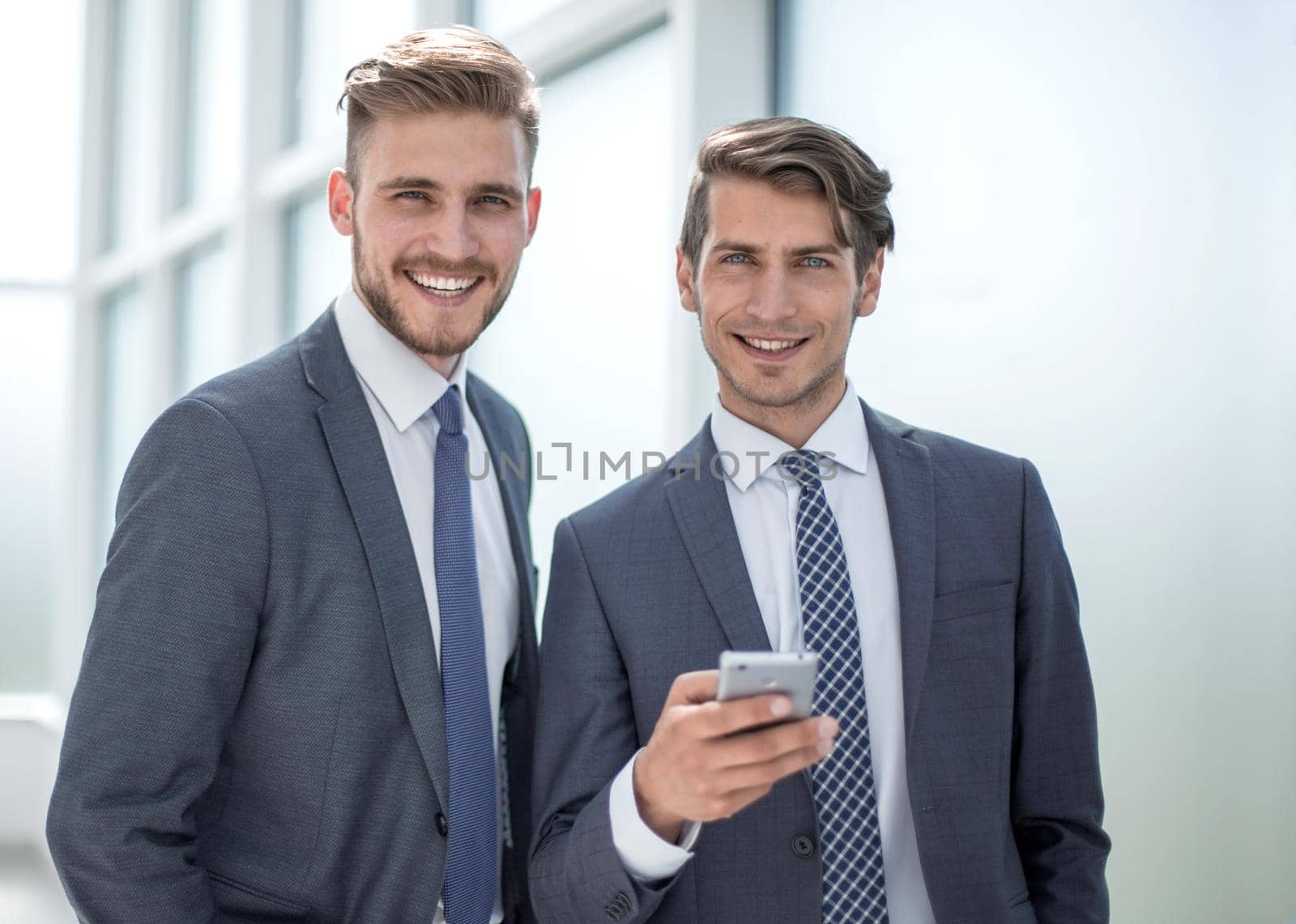 close up.business colleagues standing in a bright office.business people