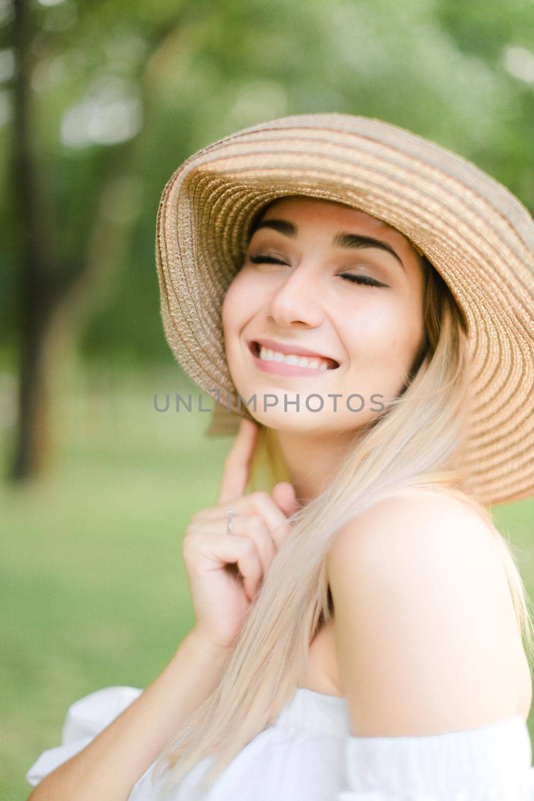 Portrait of young cute caucasian girl wearing hat and smiling. Concept of beauty, female person and summer fashion.