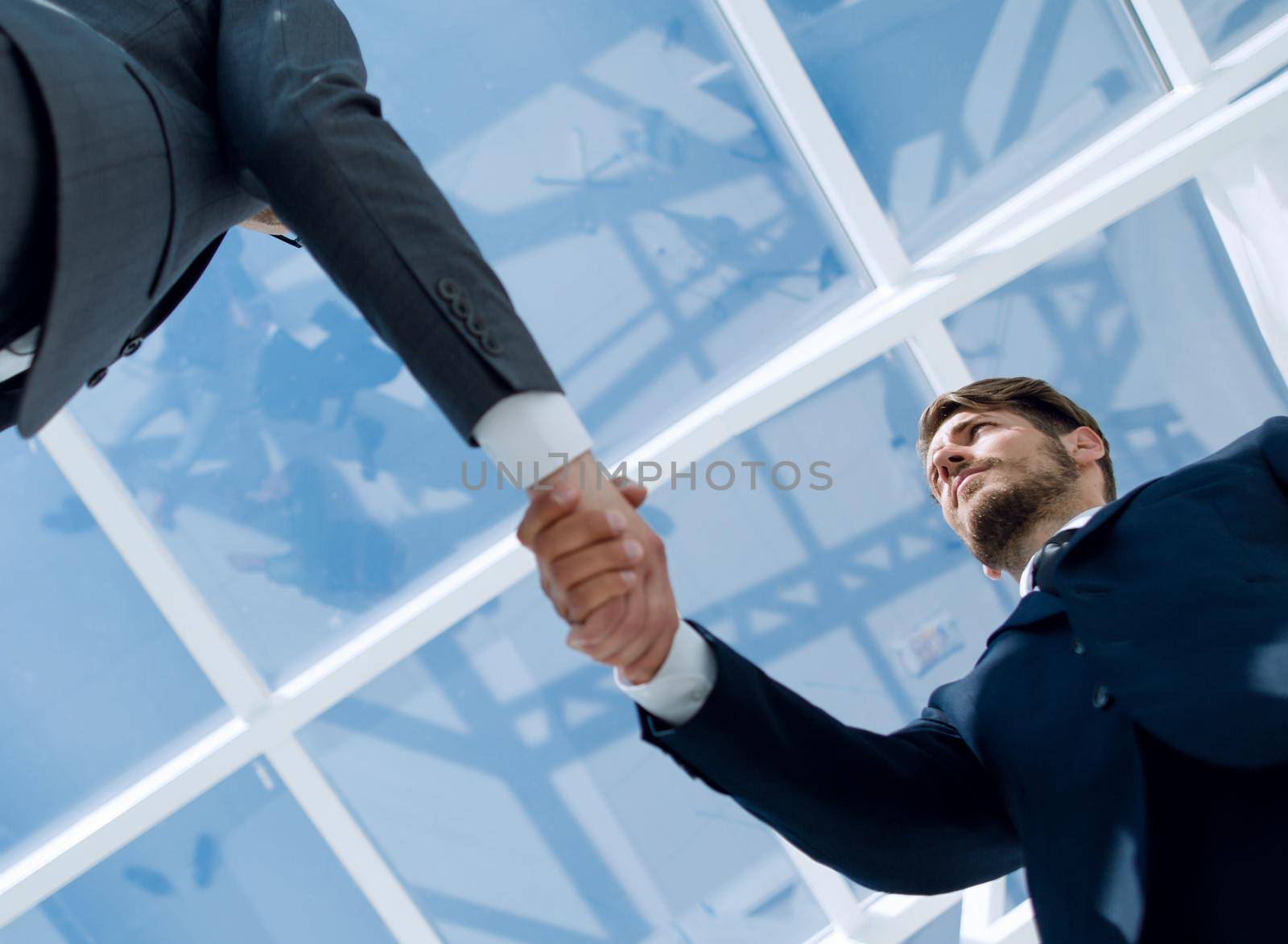 business meeting, handshake close up in office background