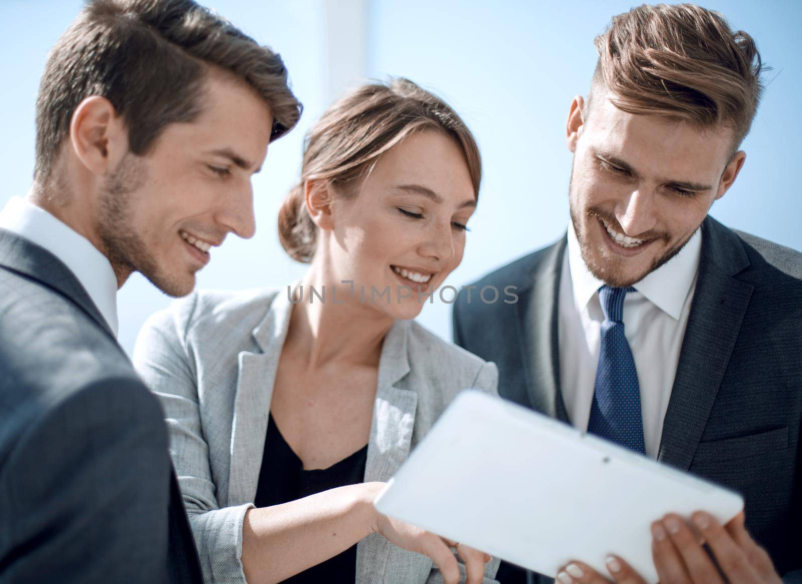 employees using a digital tablet to work in the office by asdf