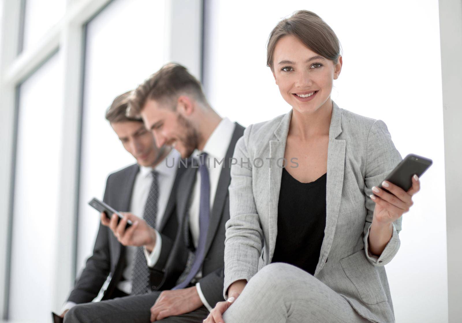 young business woman sitting in office lobby during work break. by asdf