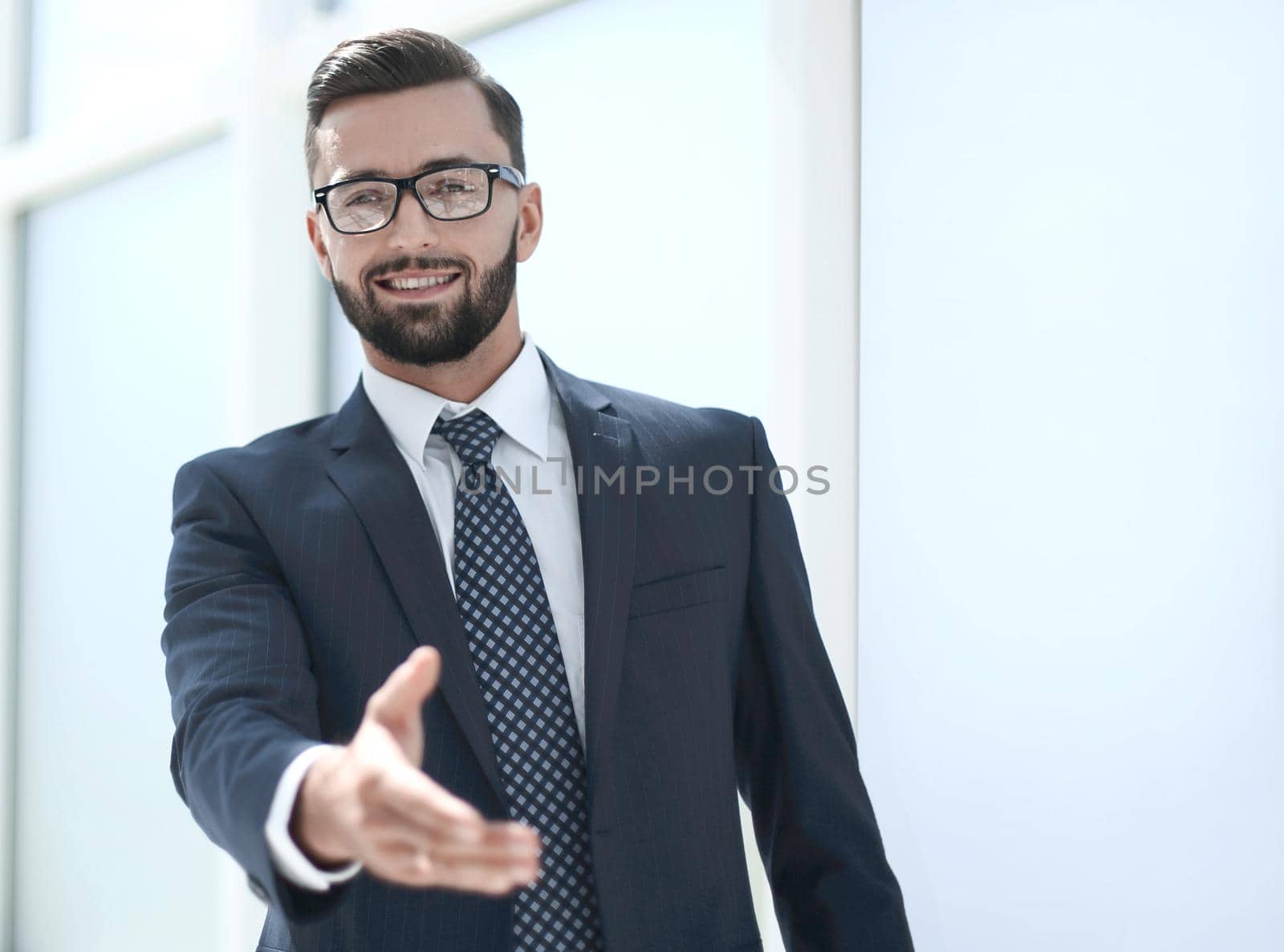 successful businessman holding out his hand for a handshake .photo with copy space