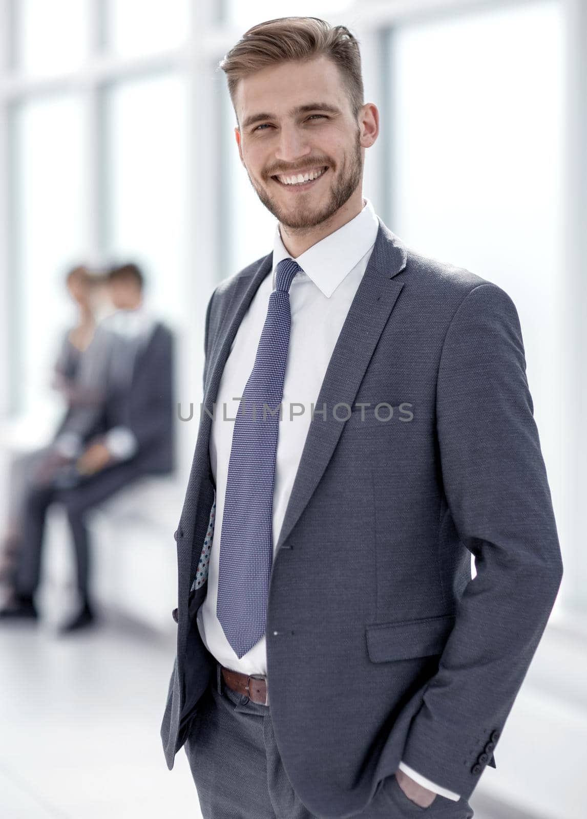 smiling businessman standing in modern office.photo with copy space