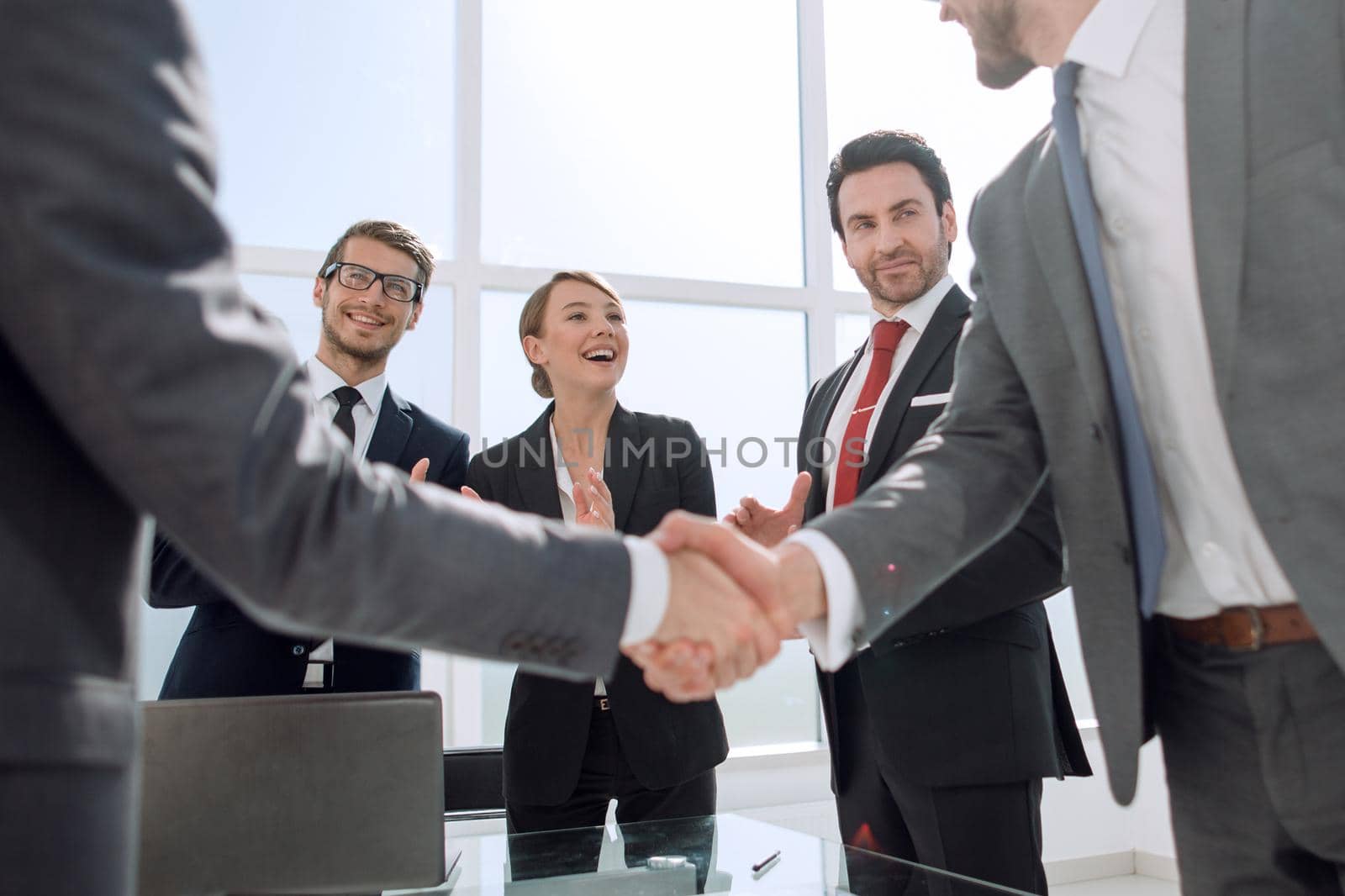 handshake business partners standing in the office.concept of partnership